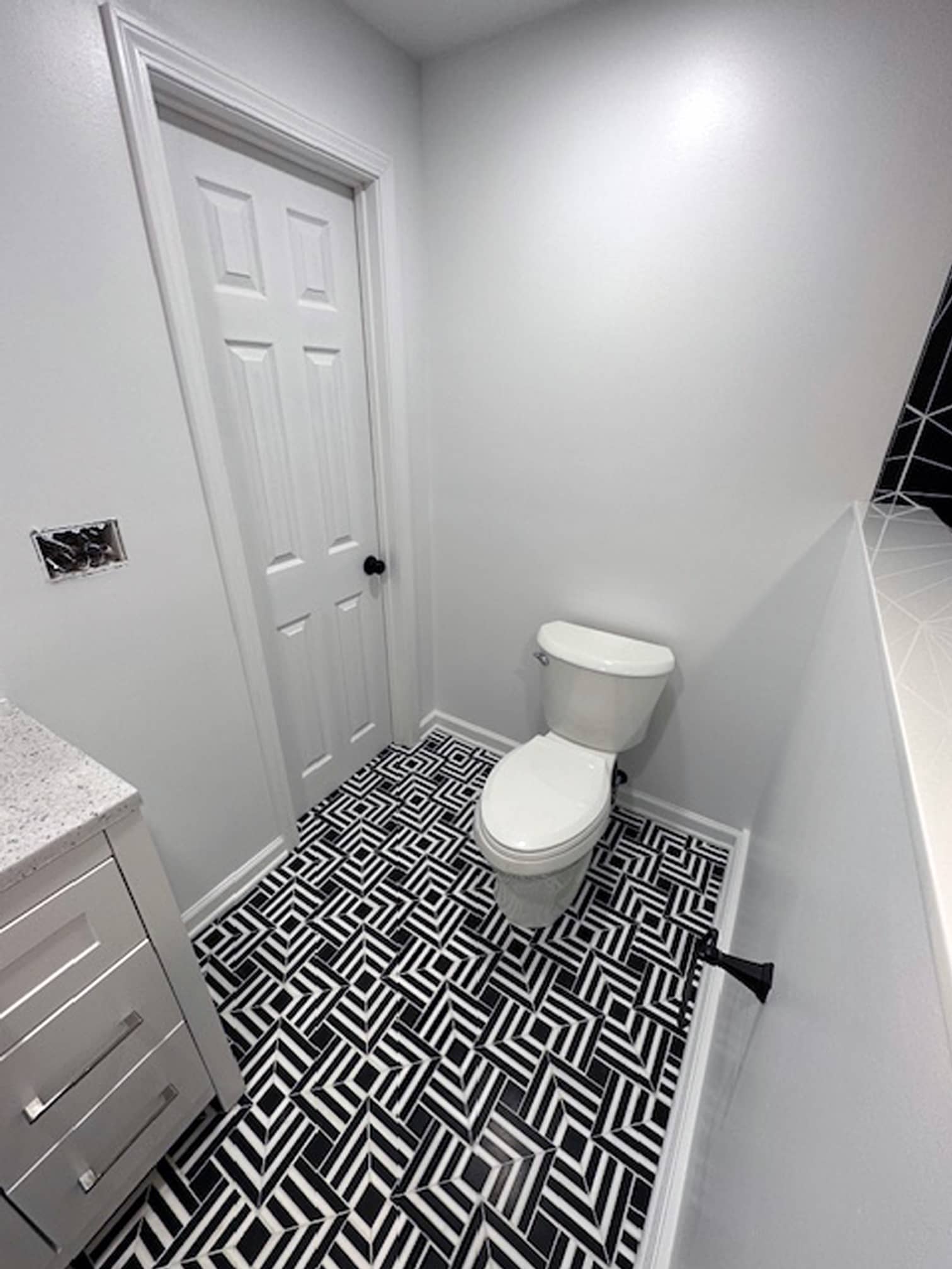 Bathroom with black-and-white patterned floor tile and modern toilet in a Gahanna home